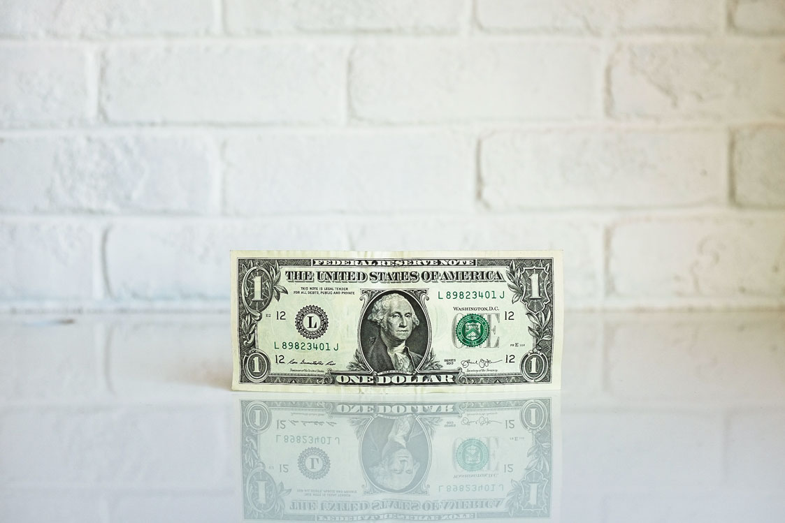 dollar standing on a white surface