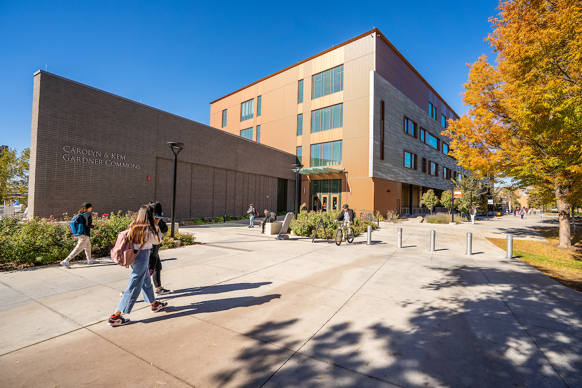 gardner commons from side angle with students walking in front of it