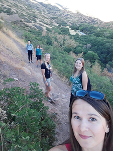 5 postdoctoral students smiling on the hiking trail